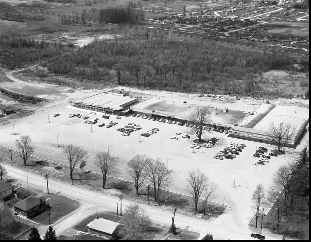 A black and white photo of a newly developed shopping plaza in Cherryhill